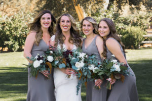 A simple and modern wedding at Triunfo Creek Vineyards, bride with bridesmaids wearing grey dresses