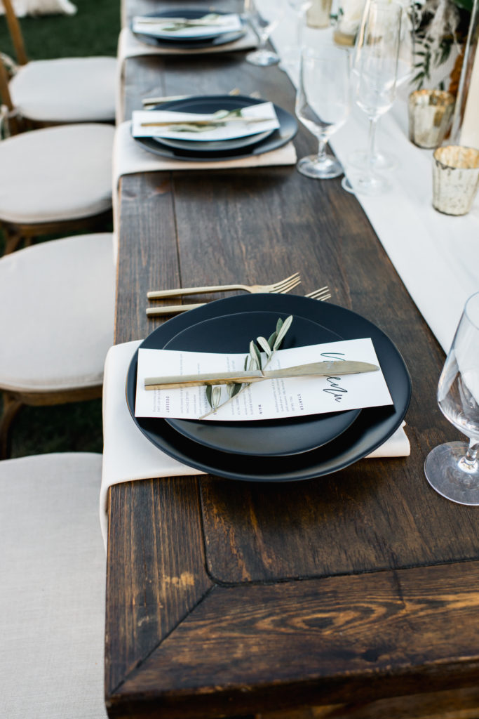 A simple and modern wedding reception at Triunfo Creek Vineyards, matte black plates