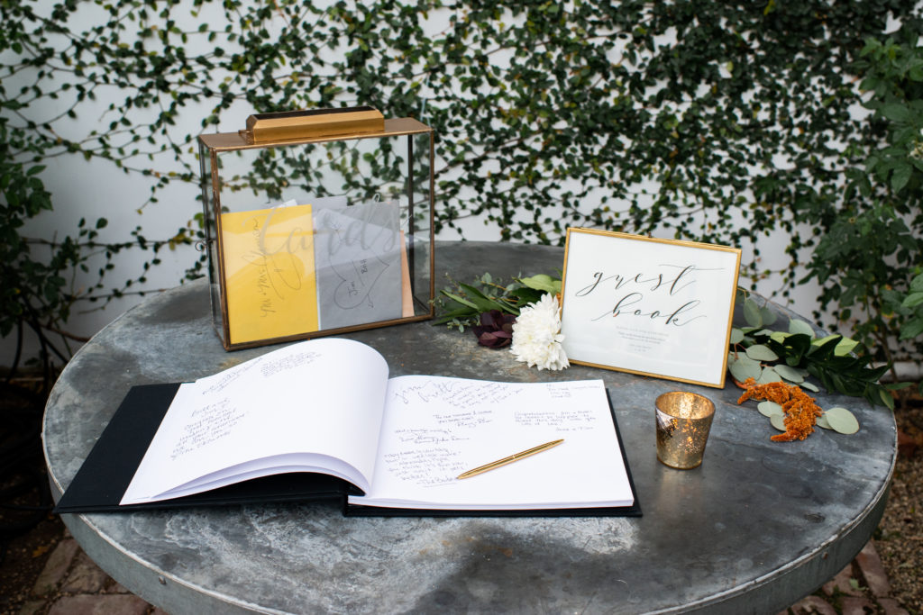 A simple and modern wedding reception at Triunfo Creek Vineyards, metallic guest book