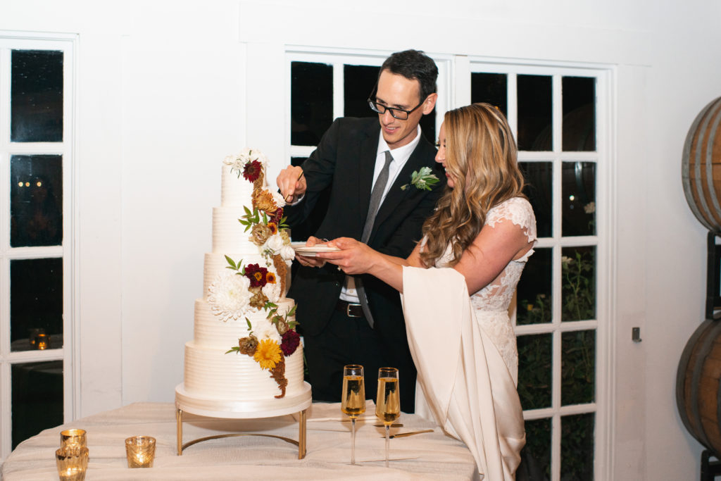 A simple and modern wedding reception at Triunfo Creek Vineyards, cake cutting