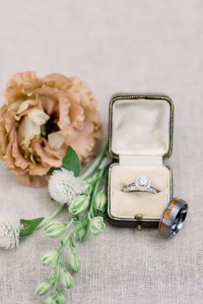 A Romantic Fall Wedding at Maravilla Gardens, wedding ring detail shot with beige flower