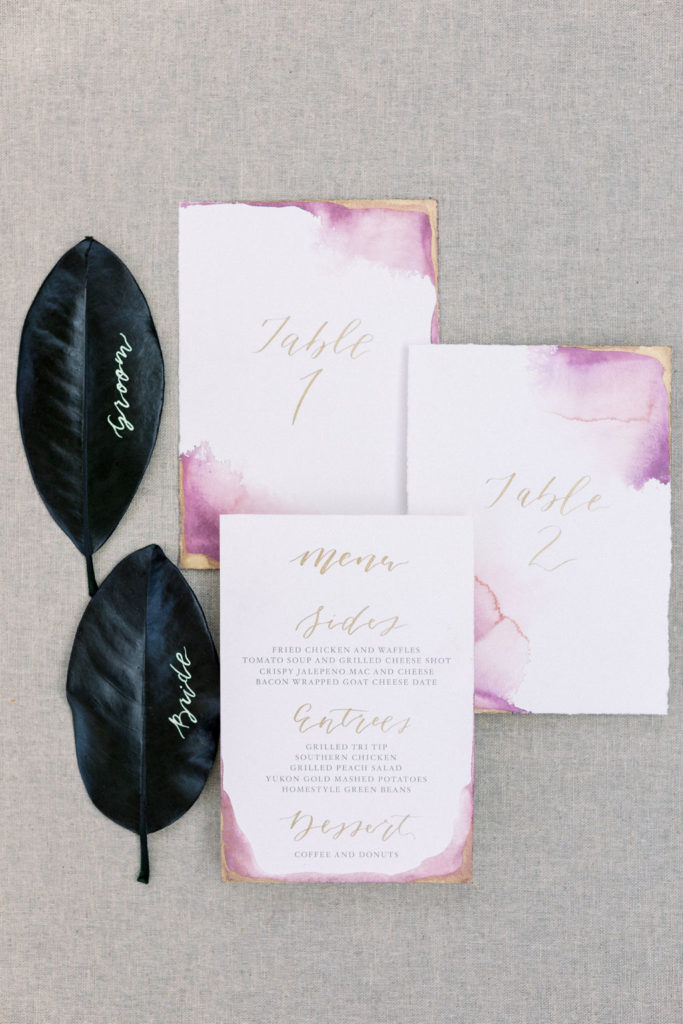 A Romantic Fall Wedding at Maravilla Gardens, magnolia leaves placards and watercolor tables numbers