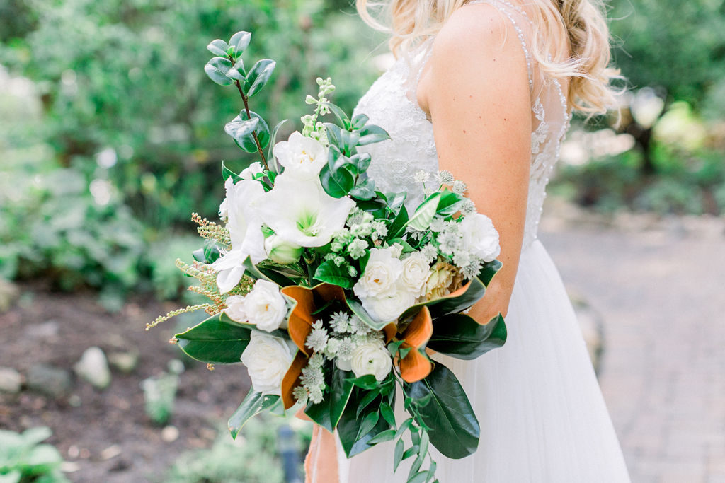 A Romantic Fall Wedding at Maravilla Gardens, bridal bouquet with magnolia leaves and white flowers