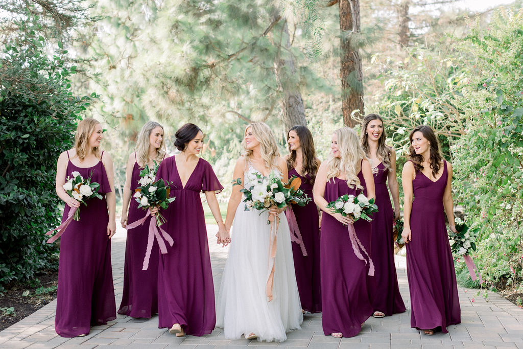 A Romantic Fall Wedding at Maravilla Gardens, bride with bridesmaids in jewel toned dresses