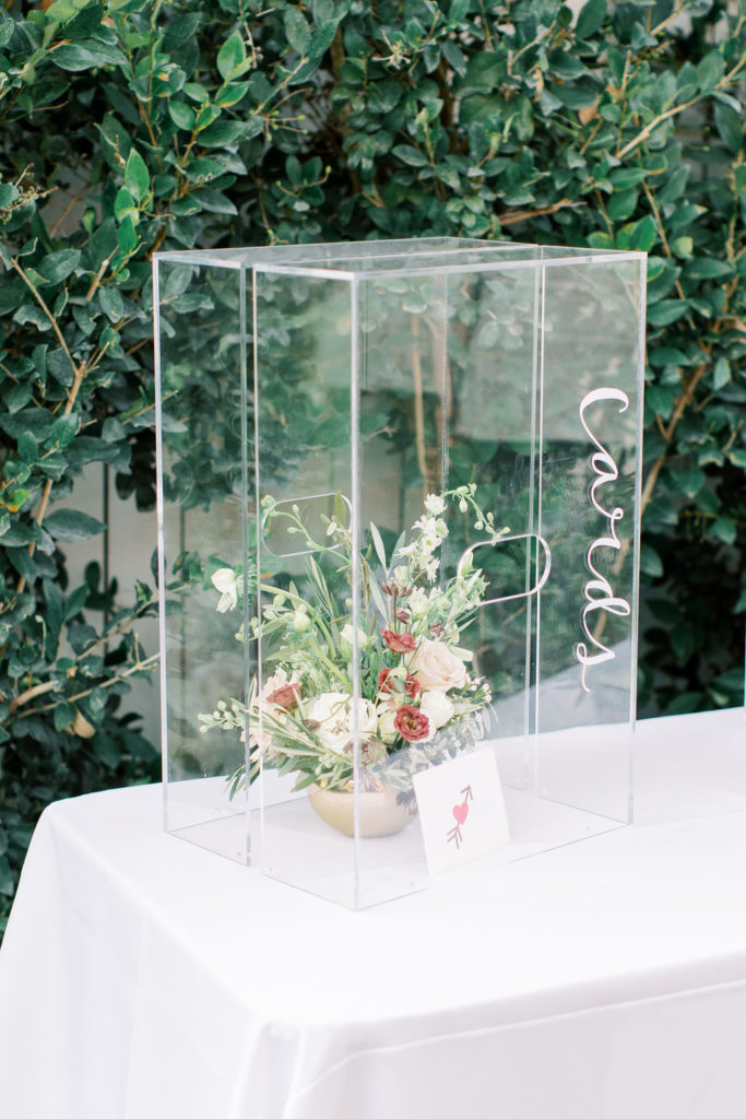 clear acrylic card box with floral arrangement inside, florist suggested arrangement repurpose