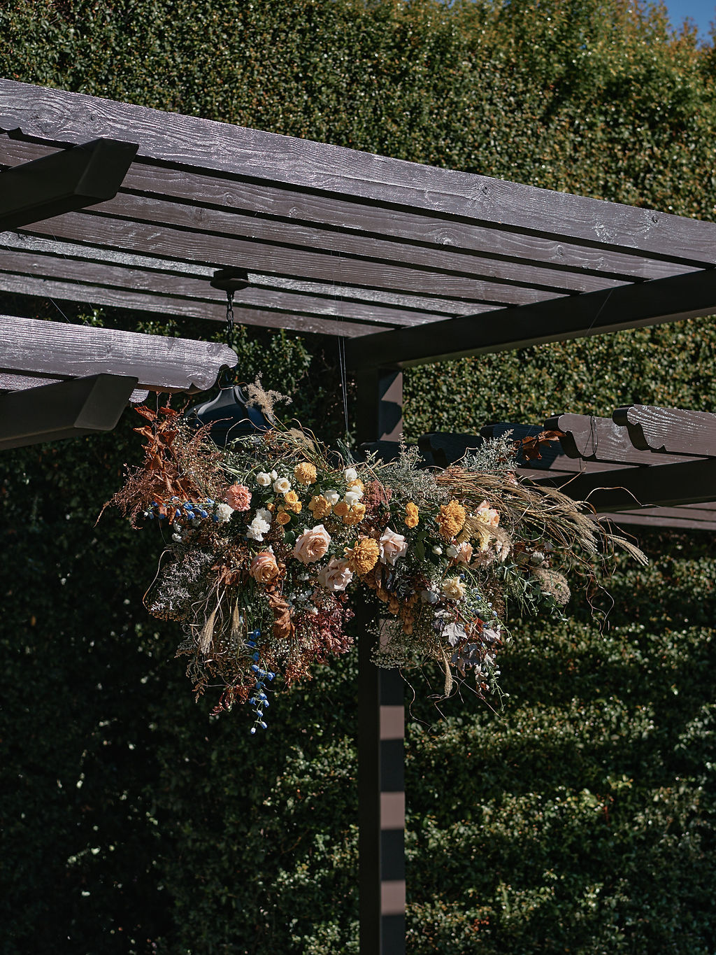 large hanging wildflower installation at the ceremony pergola at the Altadena Country Club