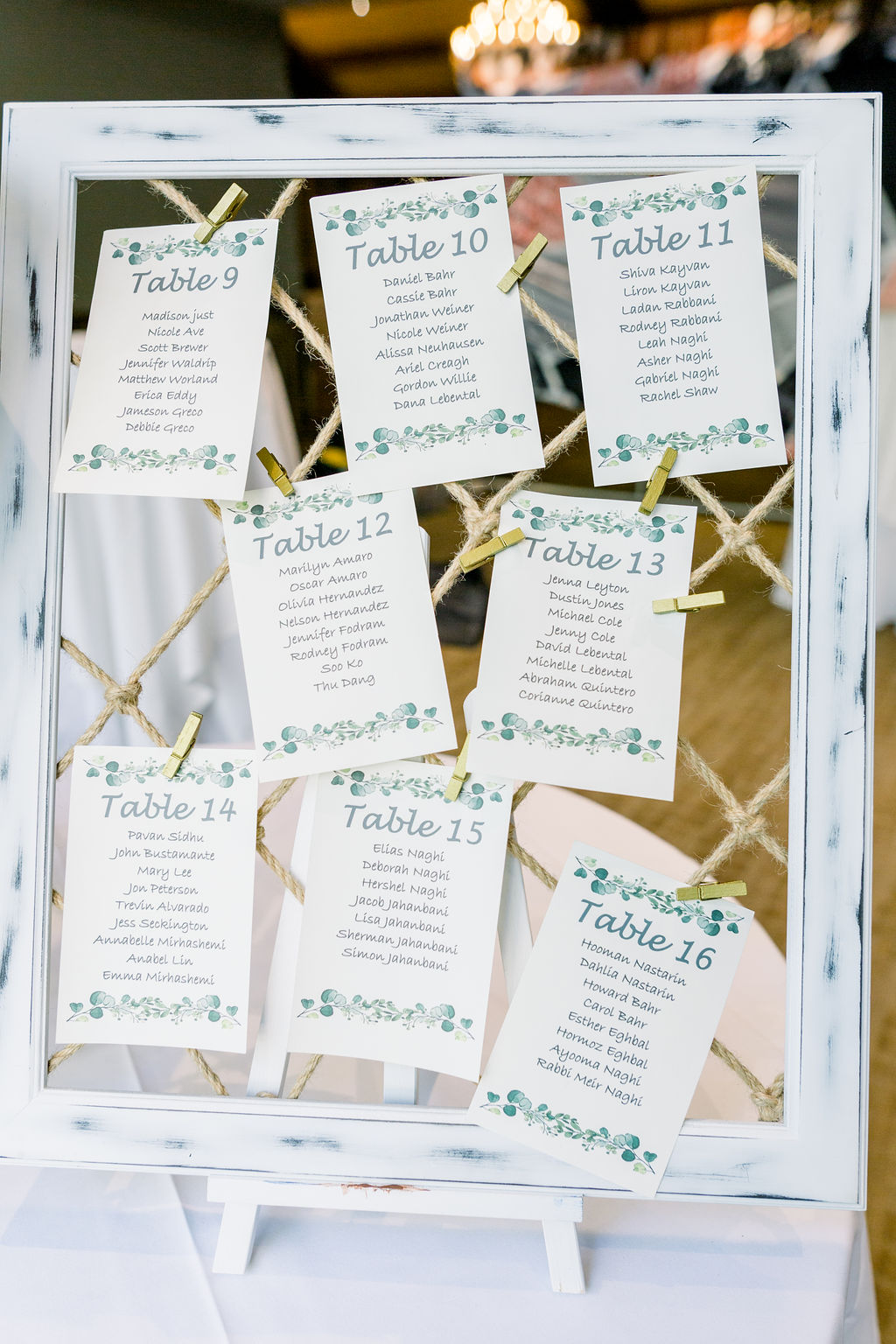 seating chart attached to rustic frame with rope