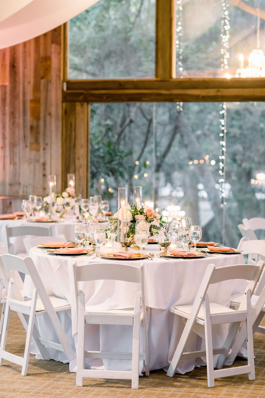 romantic and glamorous wedding reception at the Redwood Room at Calamigos Ranch with pink napkins and florals