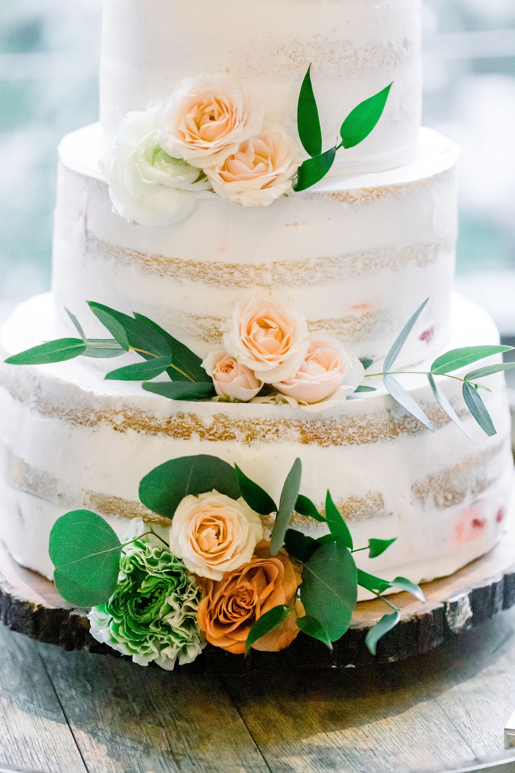 three tier naked wedding cake with pink flowers 