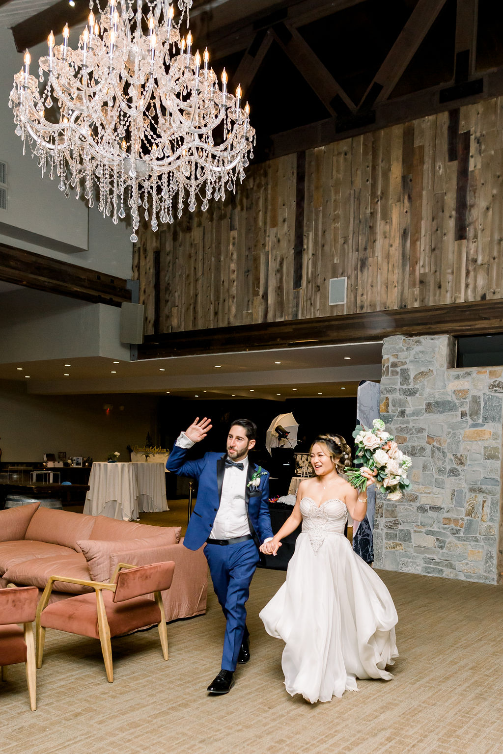 bride and groom walk into wedding reception at Redwood Room at Calamigos Ranch