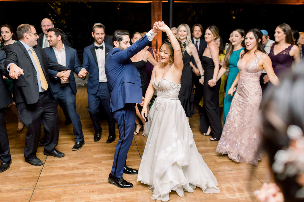 bride and groom dance with guests during reception at Calamigos Ranch