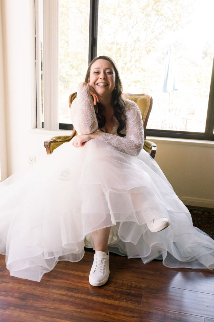 bride posing for photos wearing sneakers