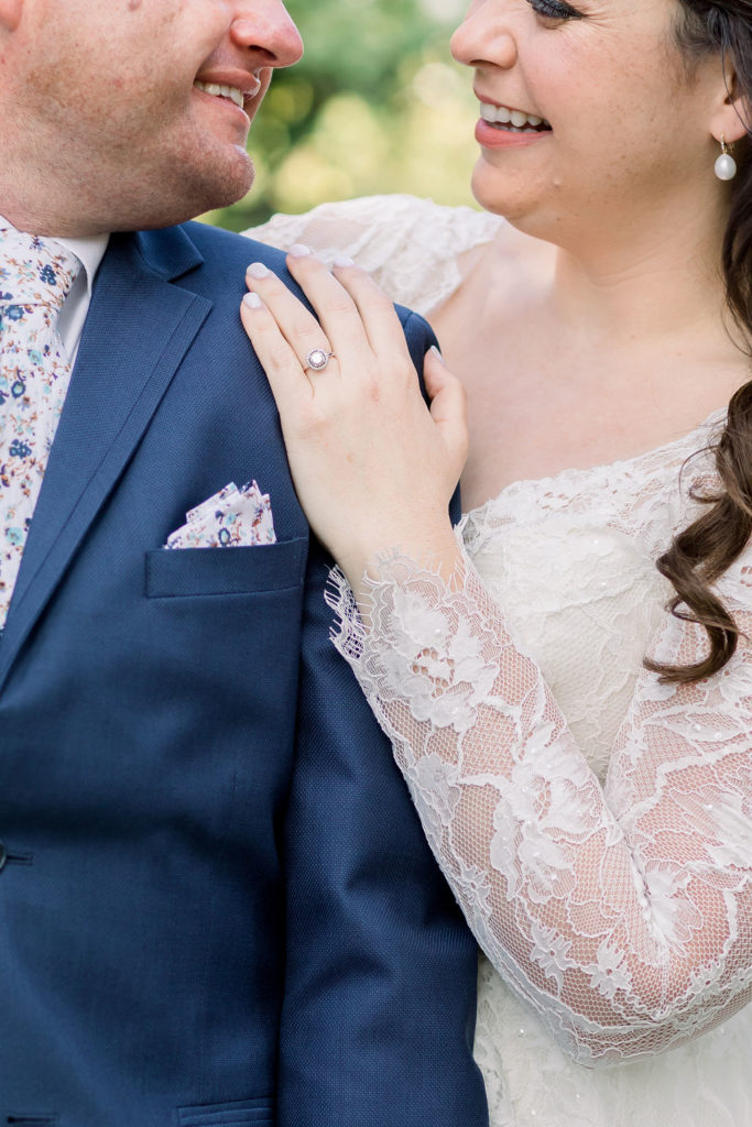 wedding ring detail shot with bride's hand on groom's shoulder