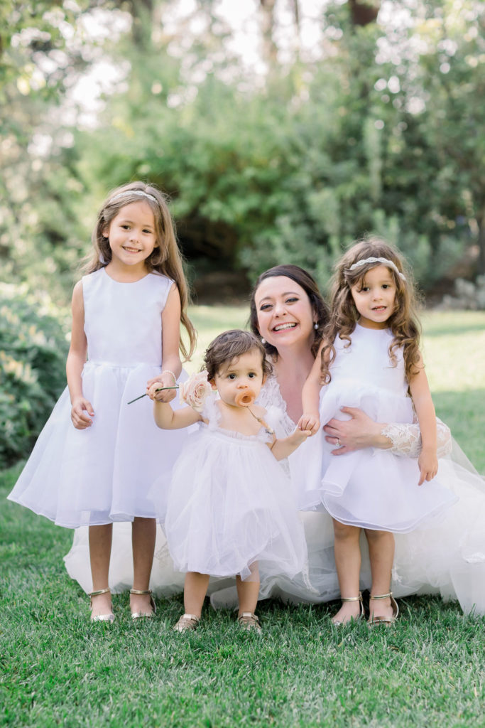 bride with flower children in white dresses