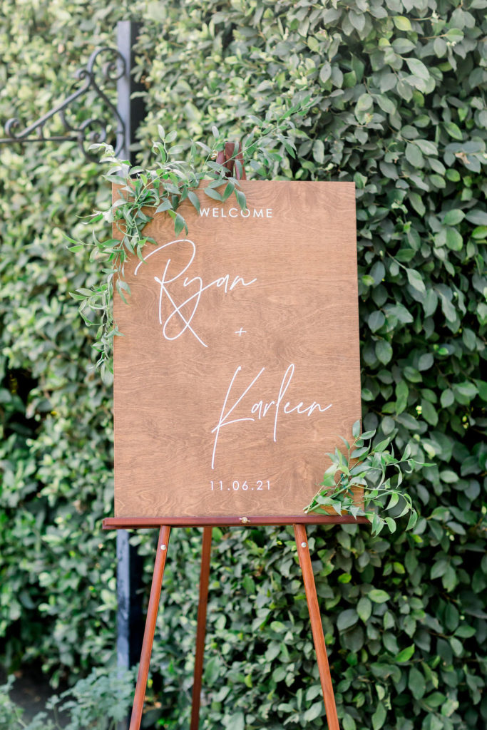 wooden wedding welcome sign with white script