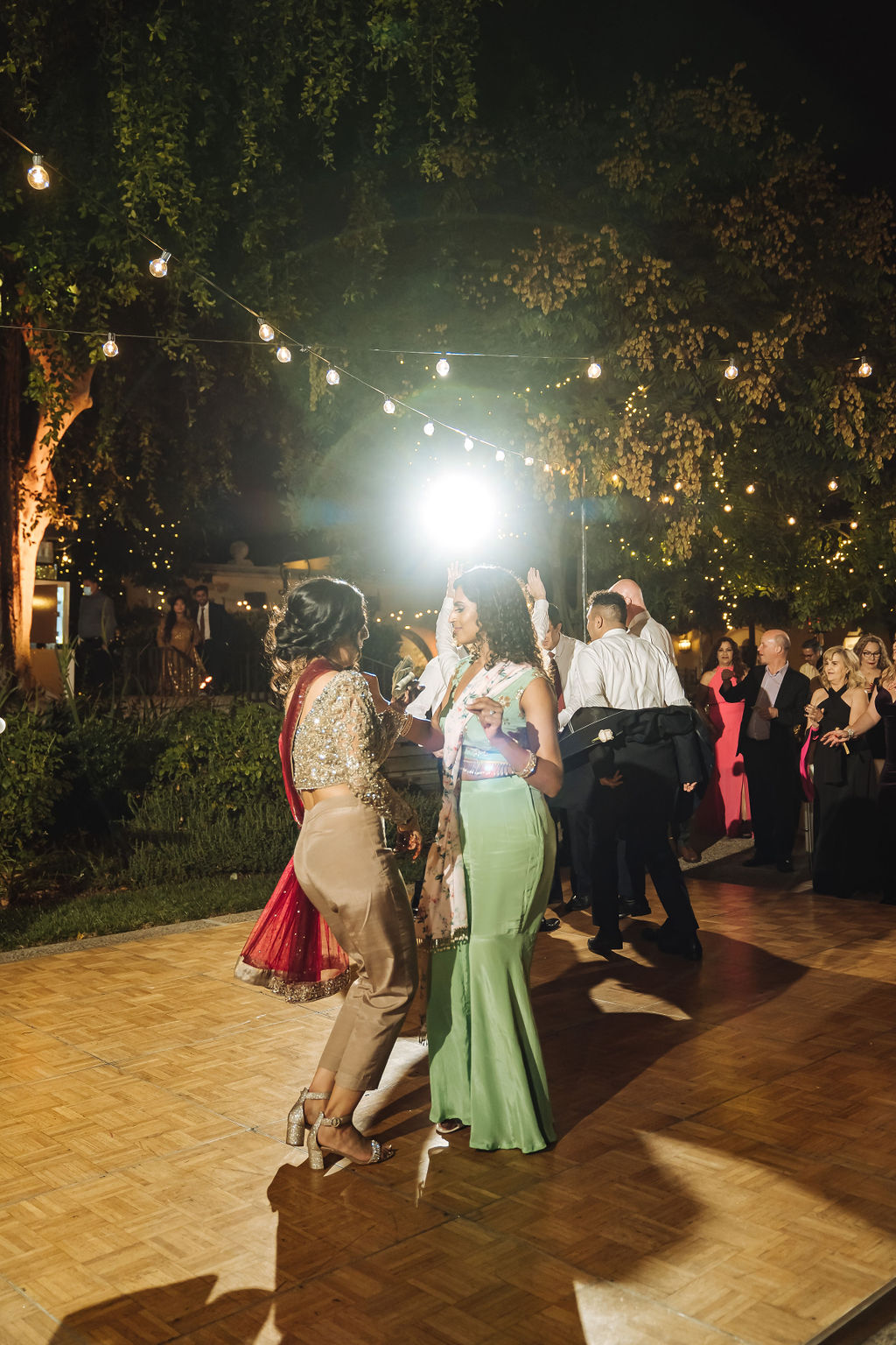 bride and groom dance with guests at wedding reception at the Los Angeles River Center and Gardens