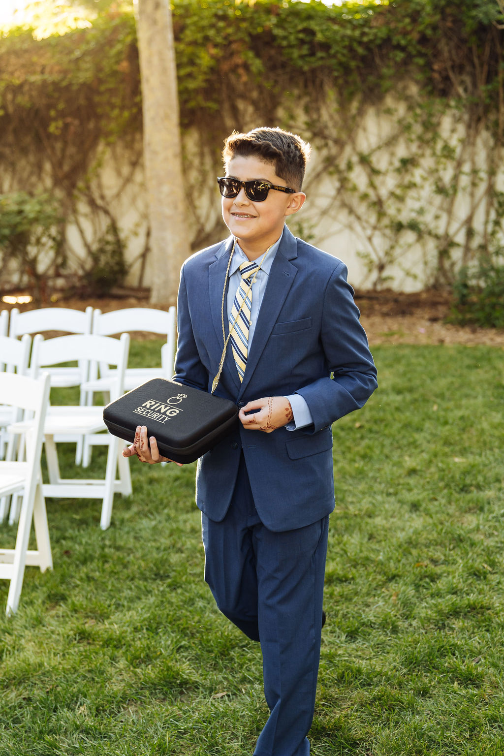 ring bearer holds suitcase that reads ring security
