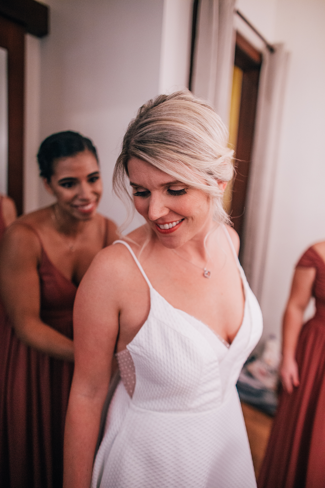 bride in textured spaghetti strap wedding dress gets ready