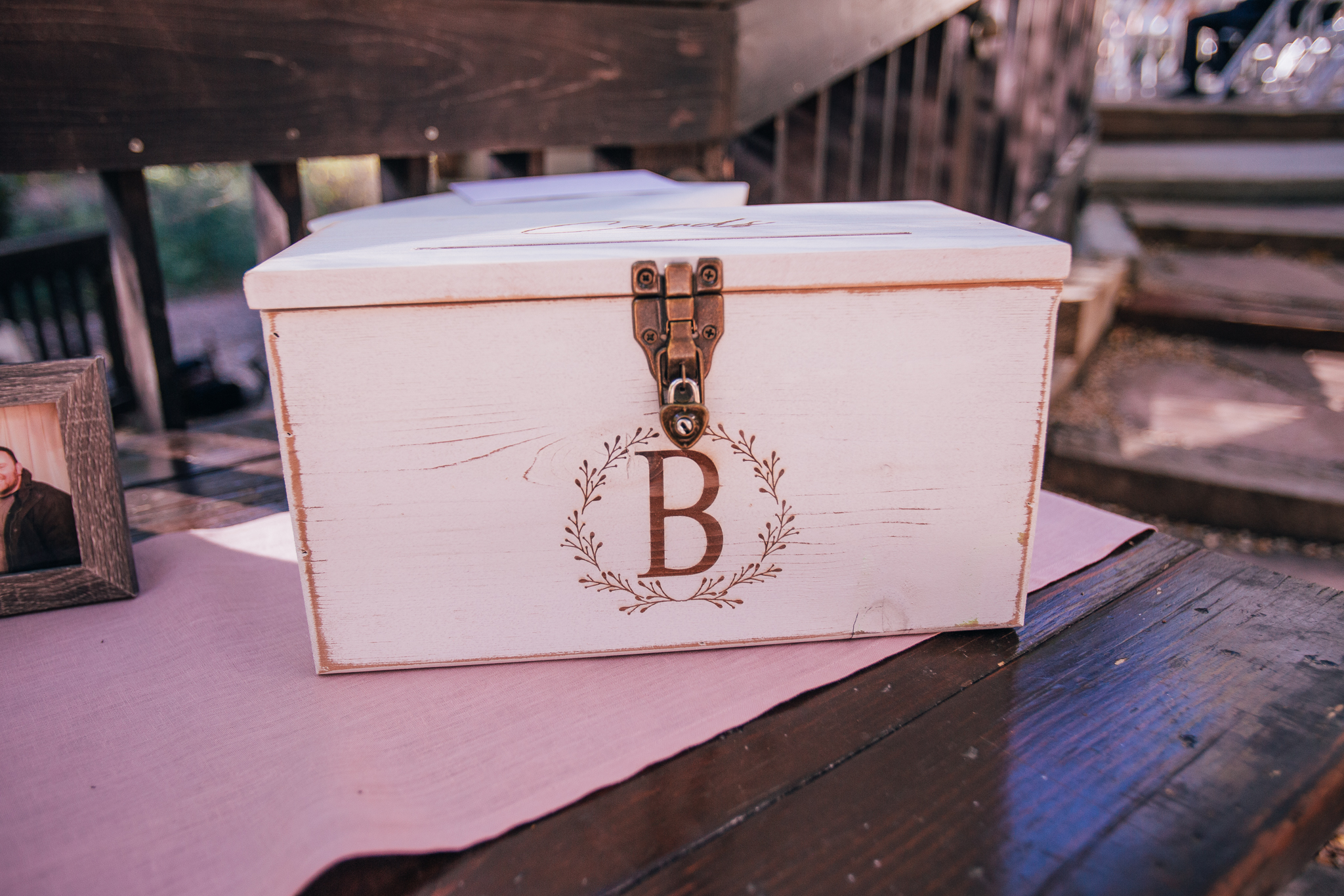 rustic card box with family crest at wedding welcome table