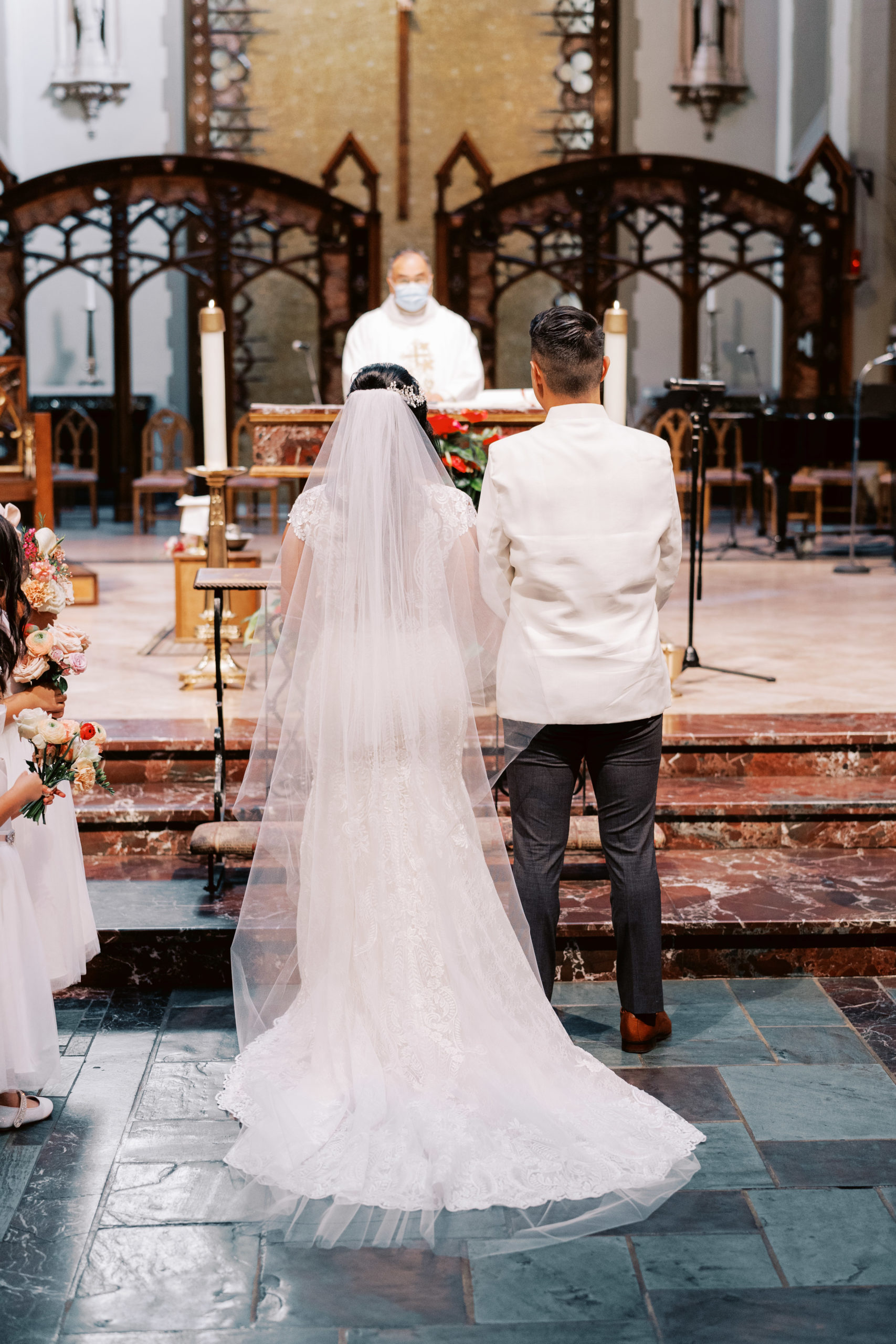 bride and groom stand at altar for Catholic Church wedding ceremony
