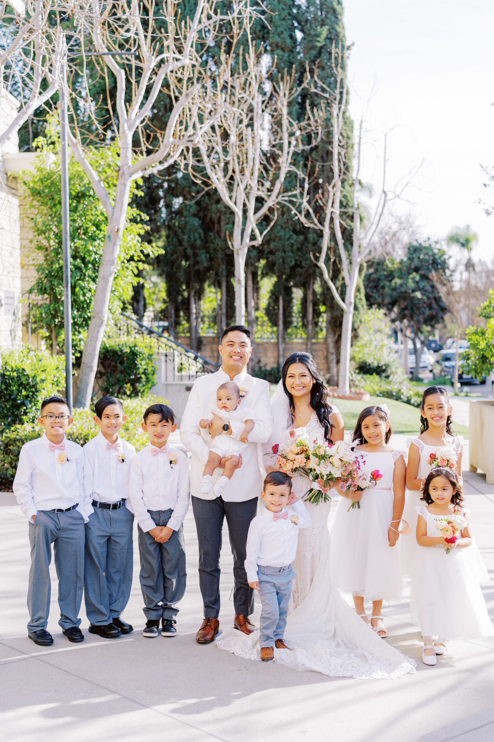 bride and groom wedding portrait shot with their baby and ring bearers and flower girls