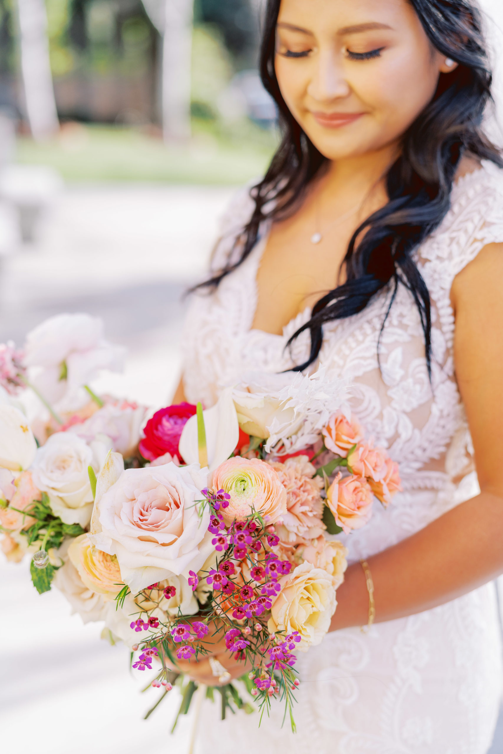 bride in lace wedding dress and tropical floral bouquet 