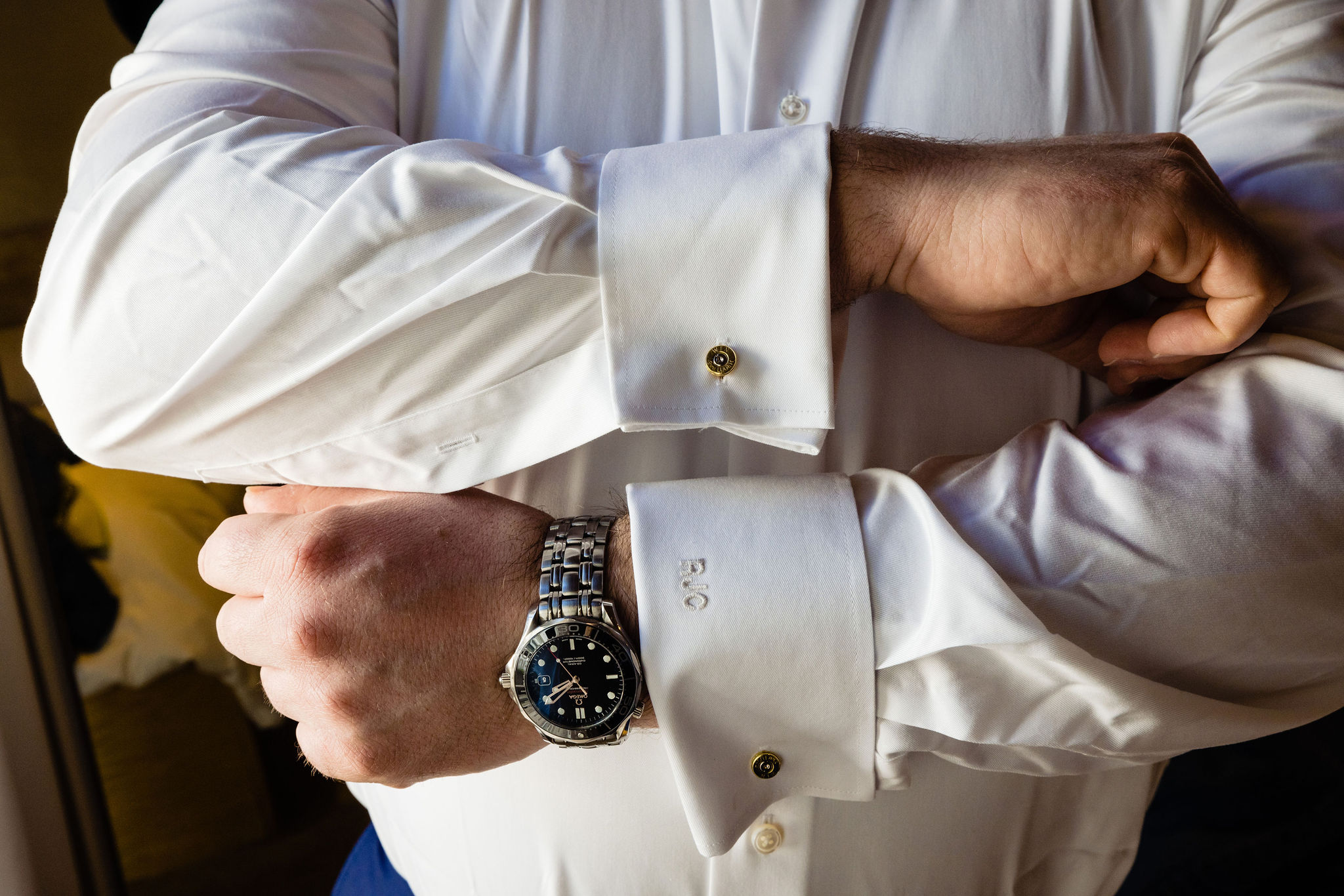 groom getting ready details with initials on cuff of shirt