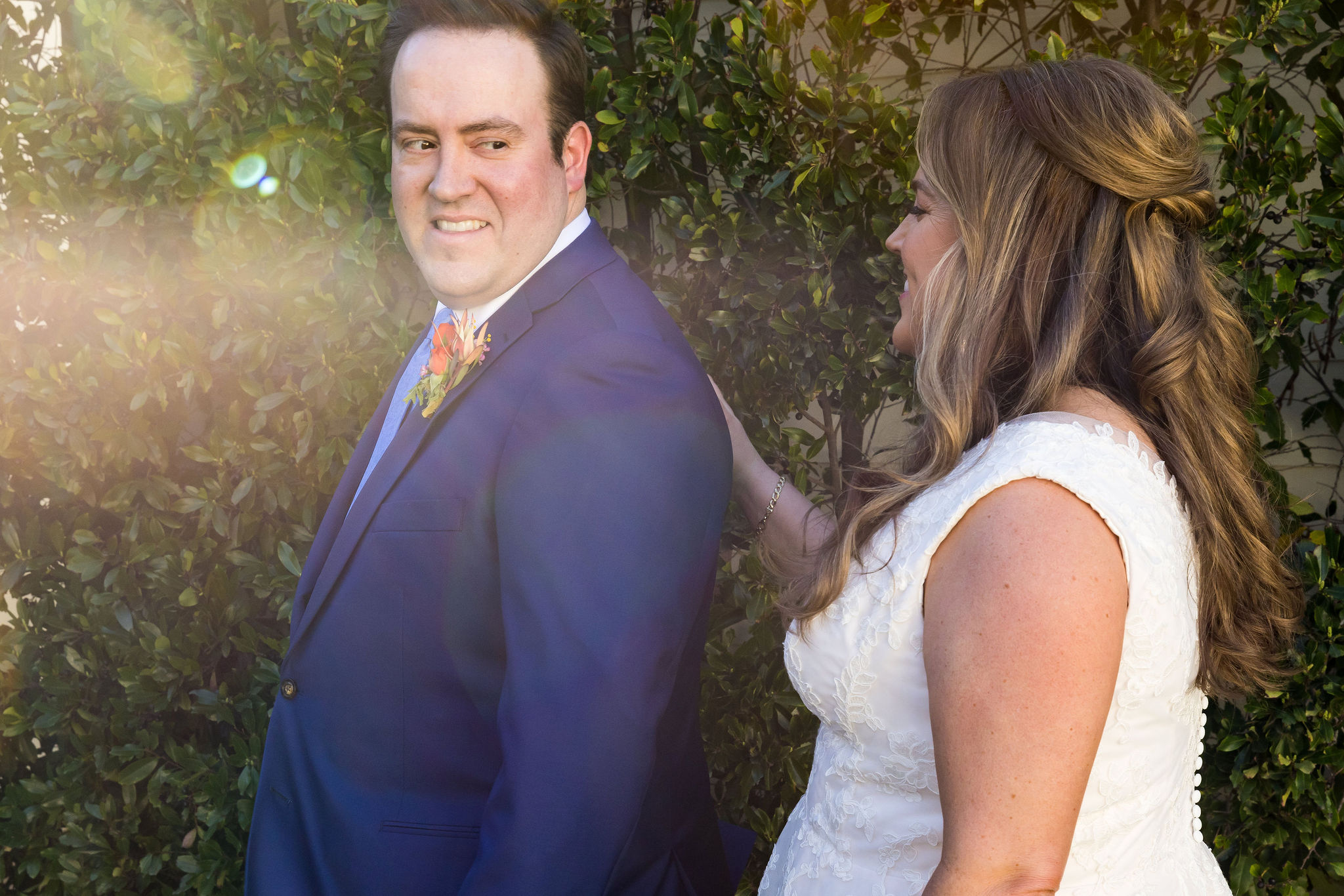 bride in v-neck lace dress does first look with groom in blue suit at Calamigos Ranch