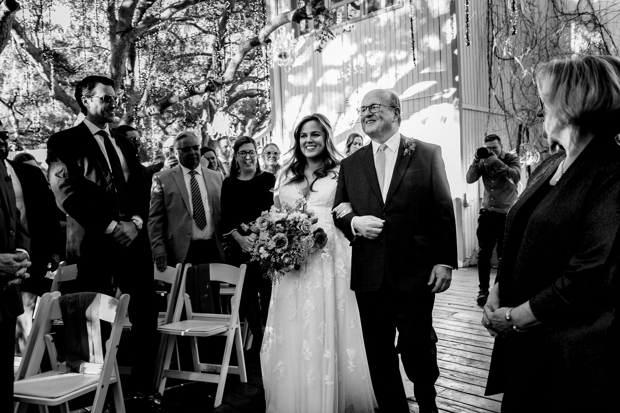 black and white phot of bride and father of the bride walking down the aisle