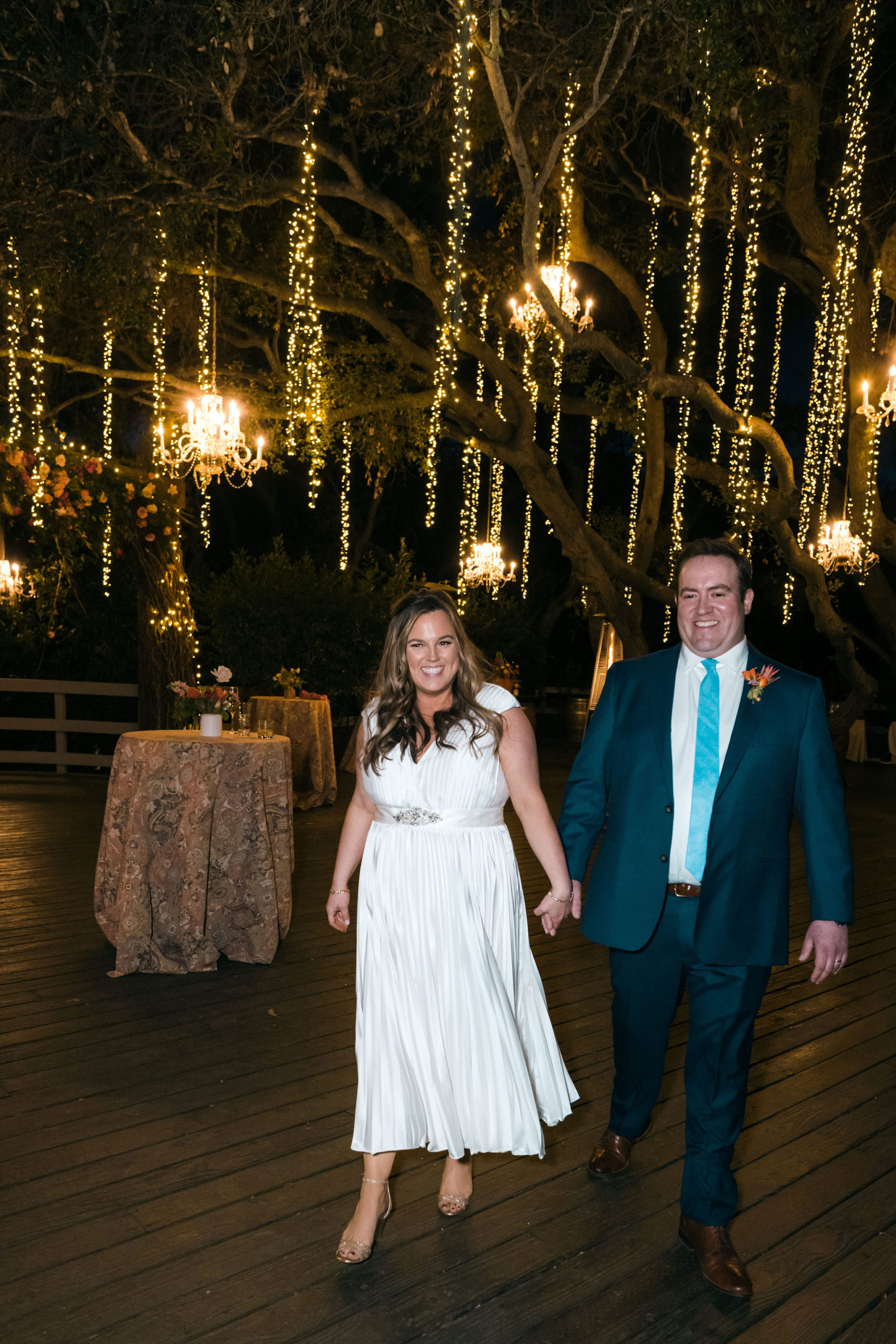 bride and groom walk into reception area of Oak Room at Calamigos Ranch