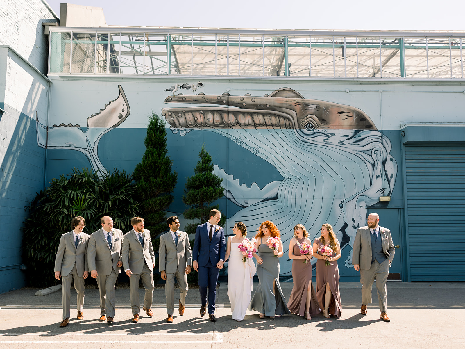 bride and groom stand with wedding party outside of The Grassroom DTLA