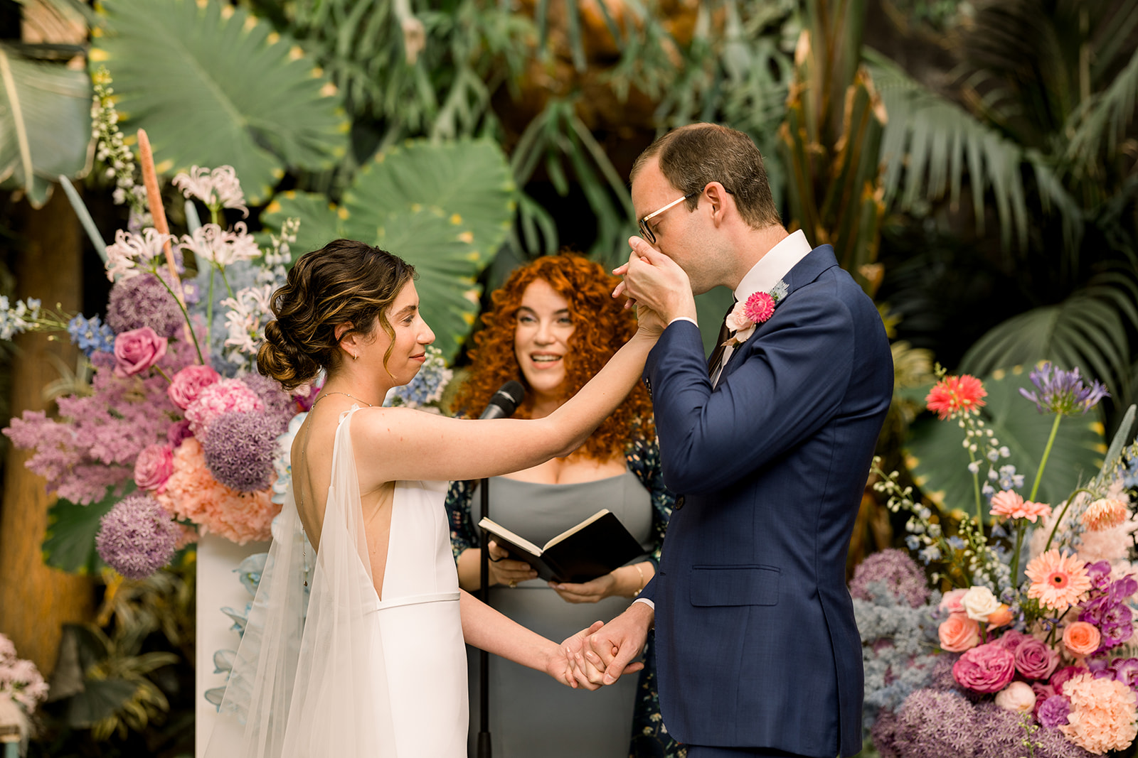 Groom kisses brides hand during wedding ceremony