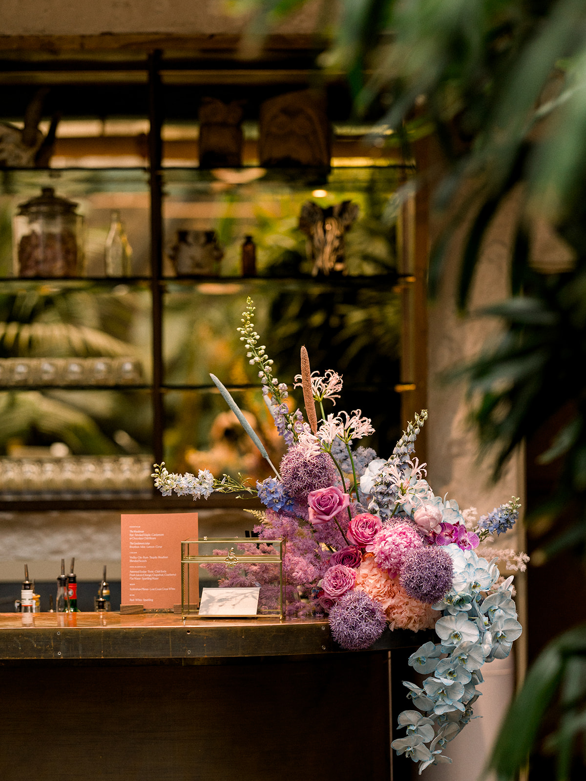 bar with gold and glass card box and wild pastel floral arrangement