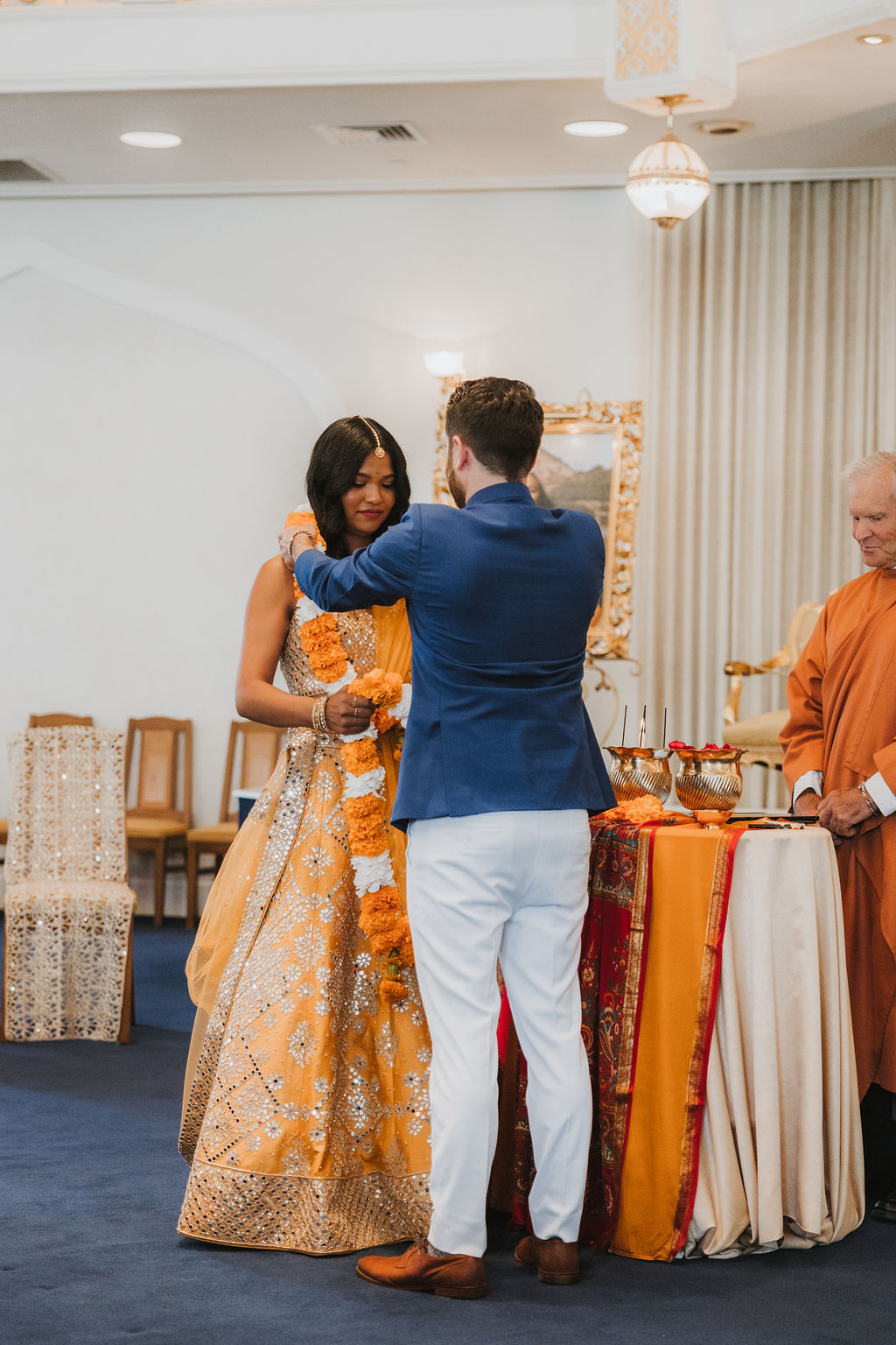 Hindu and Christian wedding ceremony at Lake Shrine Temple in Malibu with orange color palette