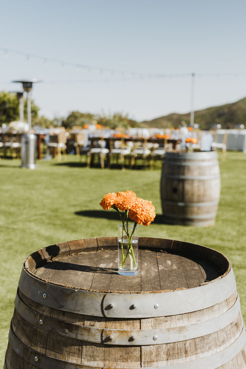 wedding reception and cocktail hour at Saddlerock Ranch with orange marigold floral arrangements