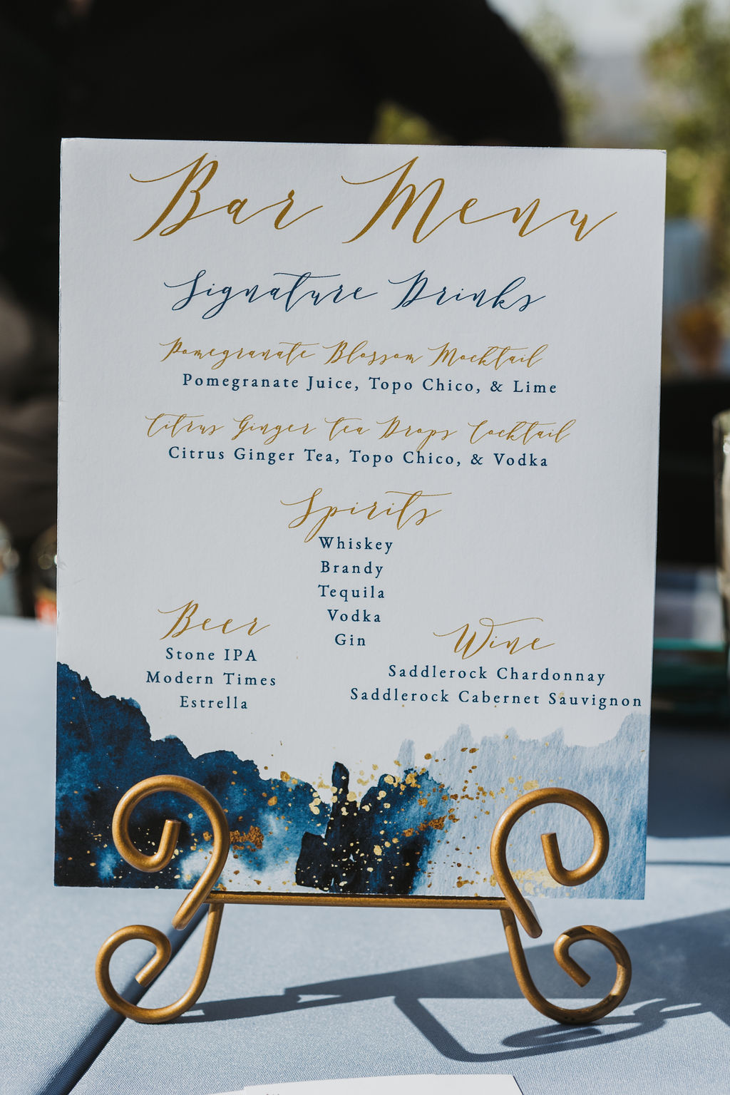 blue and gold bar menu wedding sign during cocktail hour