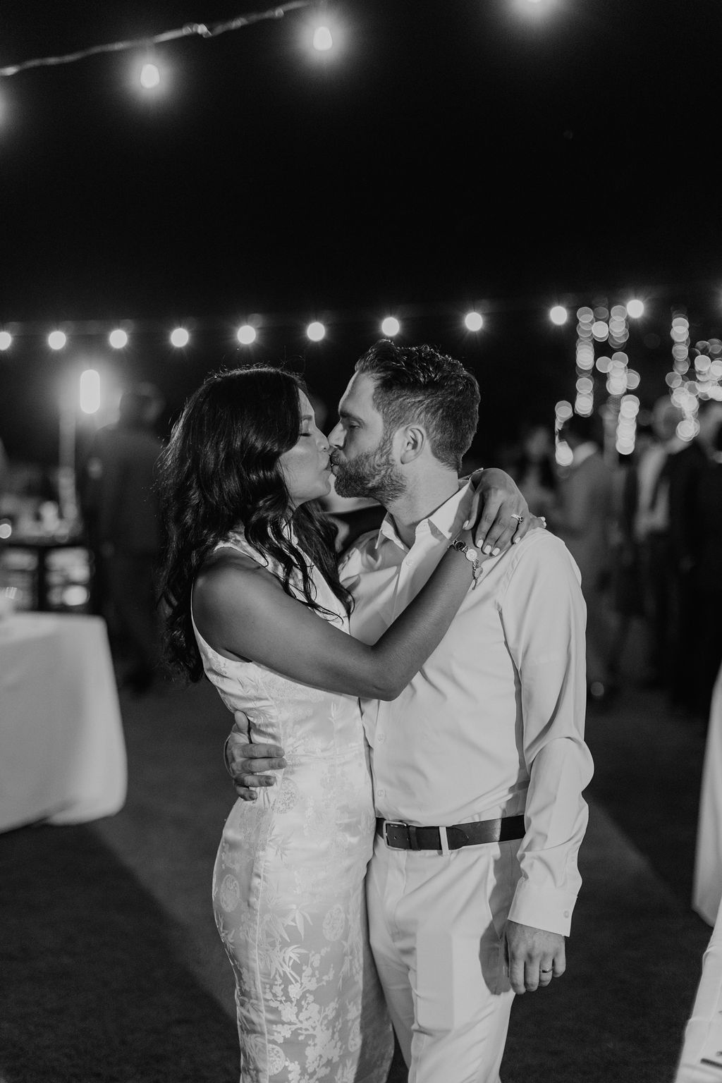 bride in white reception dress kisses groom at Saddlerock Ranch