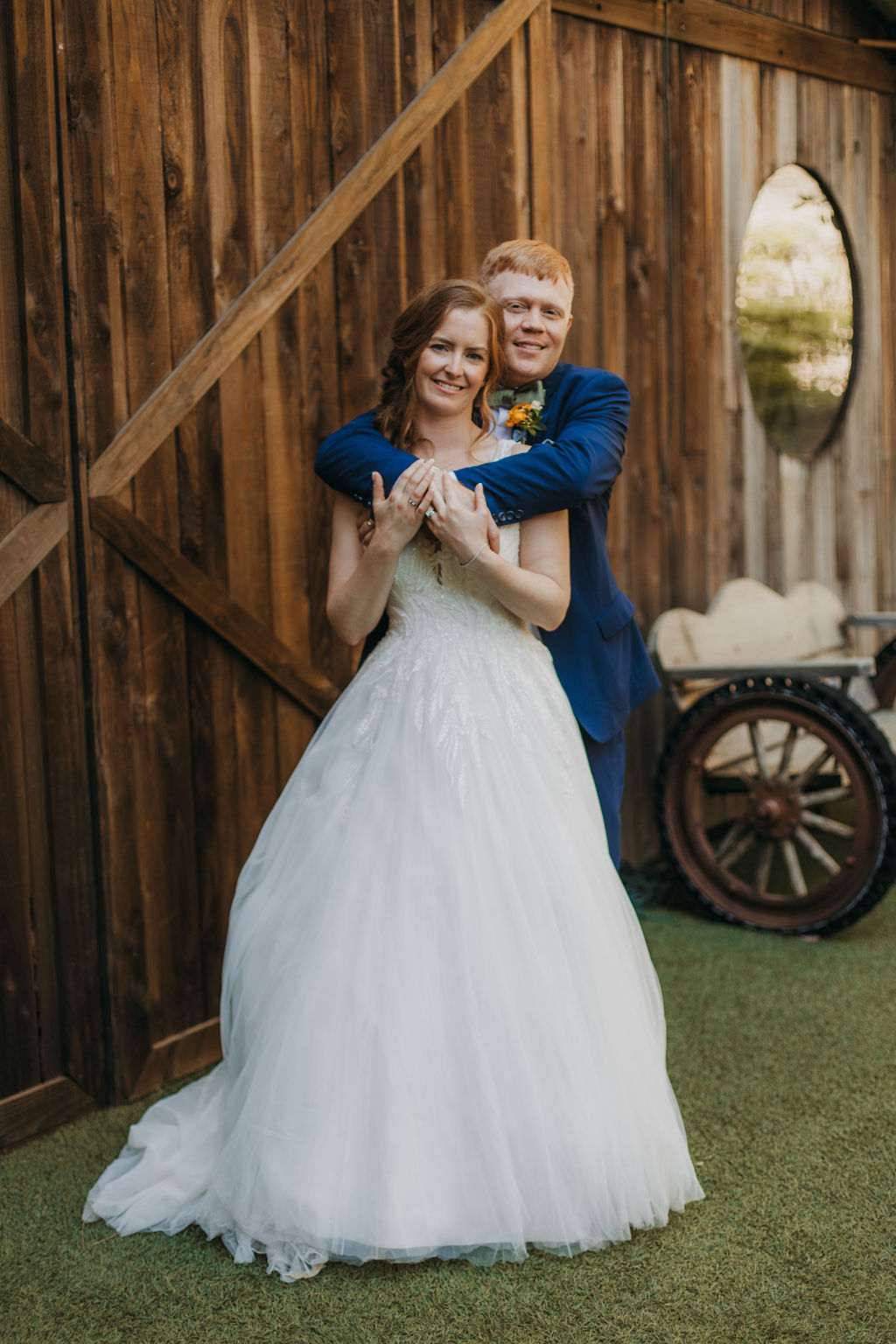 bride in v-neck embellished tulle ballgown wedding dress with groom groom in navy blue suit and green bowtie portrait shots at Calamigos Ranch