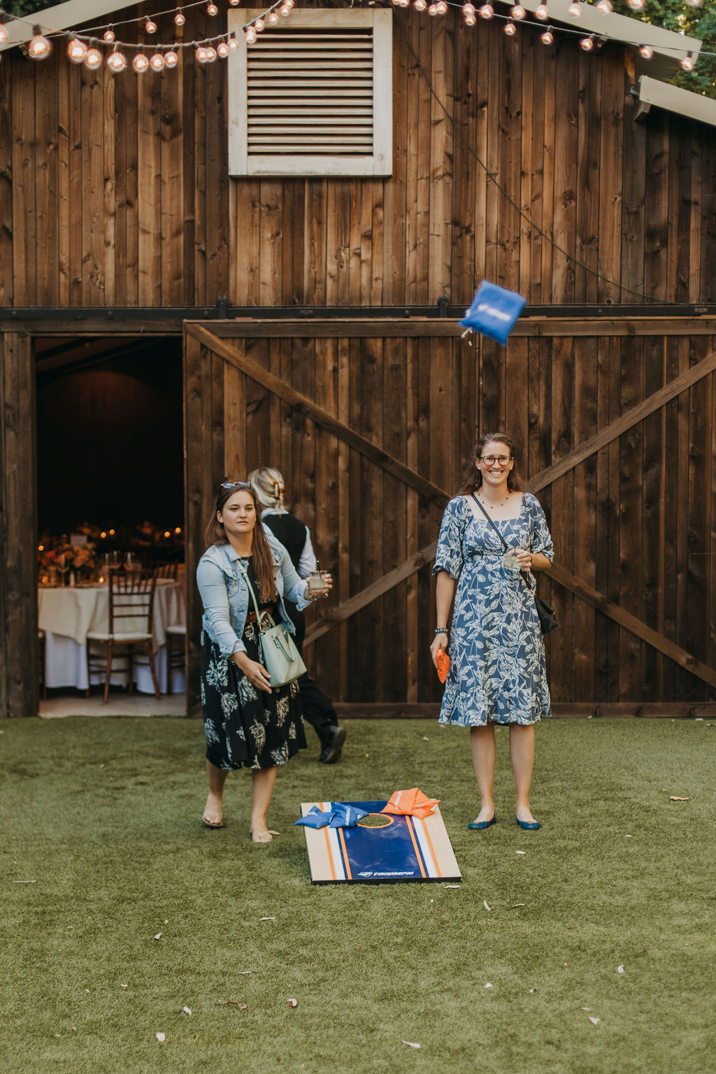 guests playing corn hole during cocktail hour