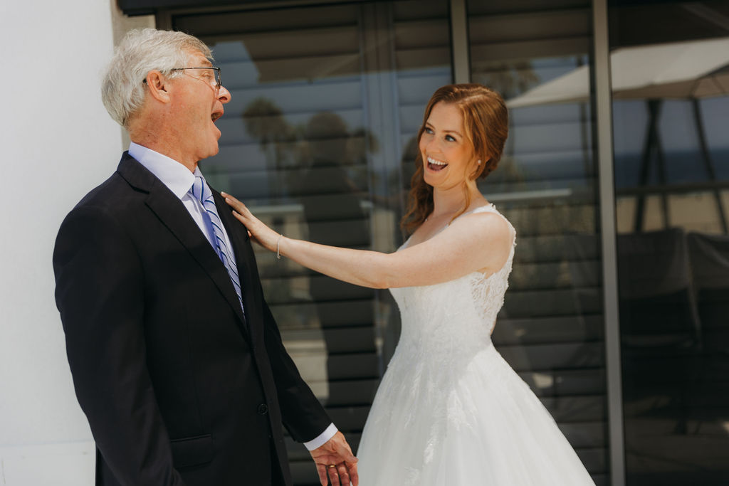 red haired bride in vneck embellished tulle ball gown does first look with father of the bride