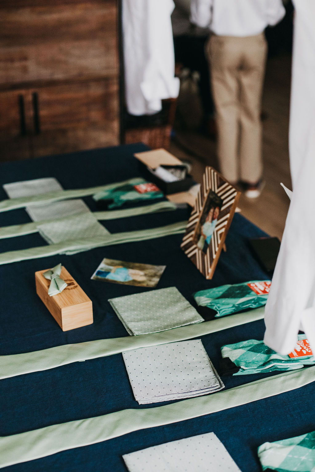 matching green groomsmen ties, pocket squares and socks on a table