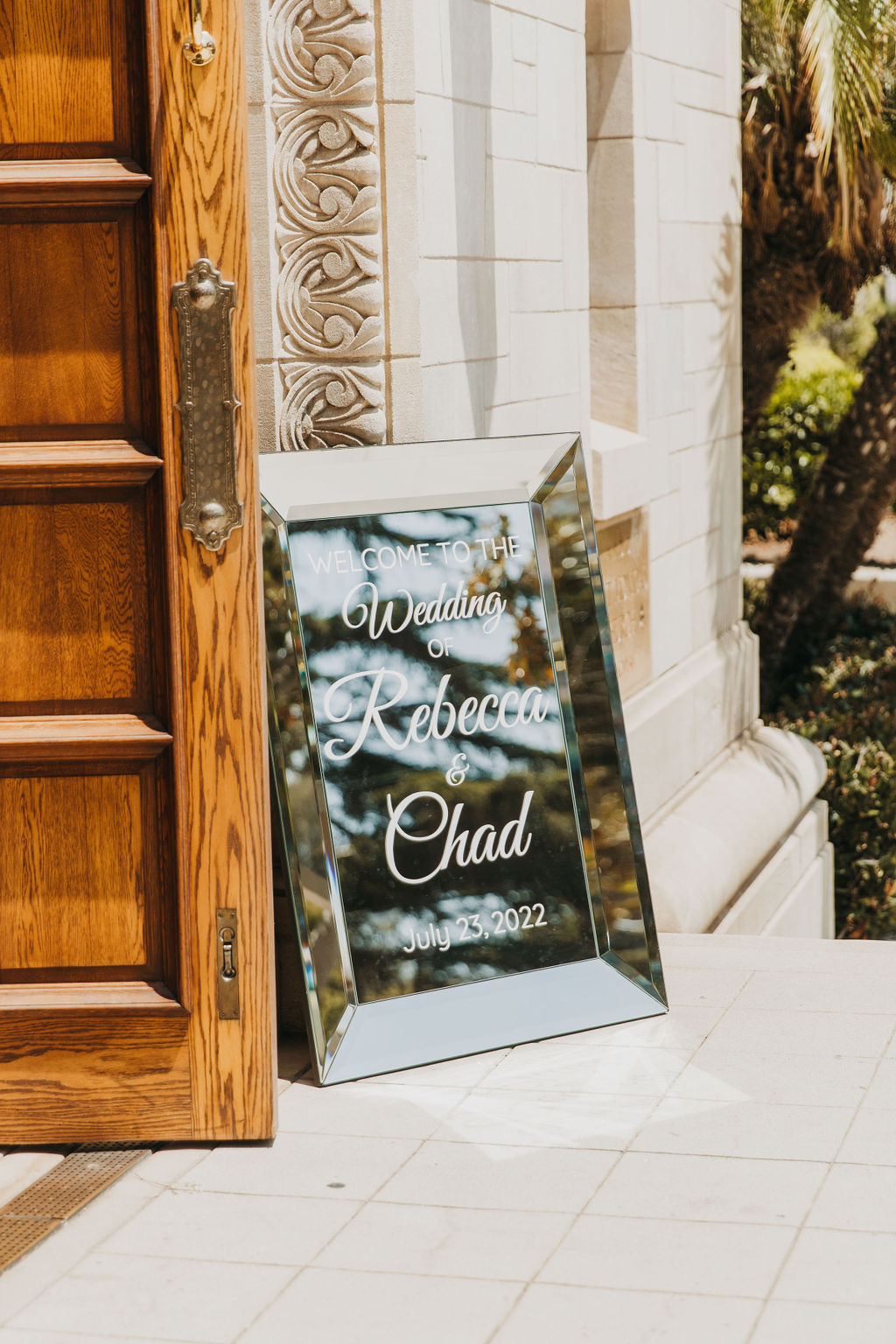 mirror wedding welcome sign in front of Catholic Church