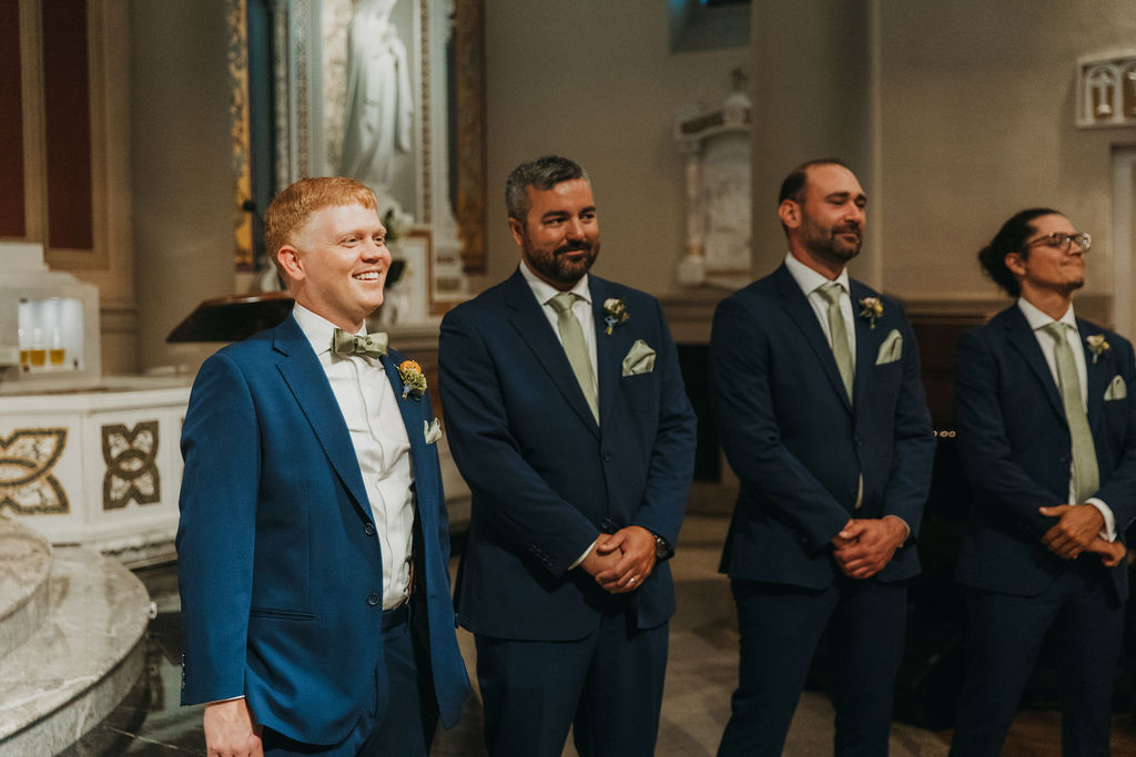 groom in navy blue suit seeing bride for first time