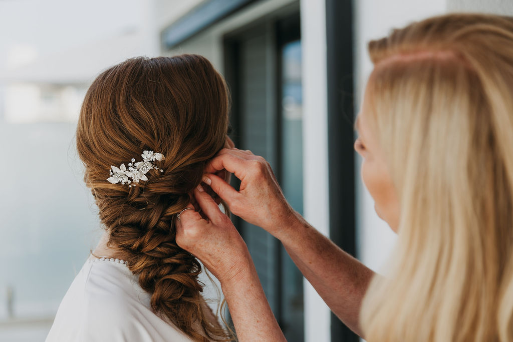 bridal hair style with side braid and embellished clip 