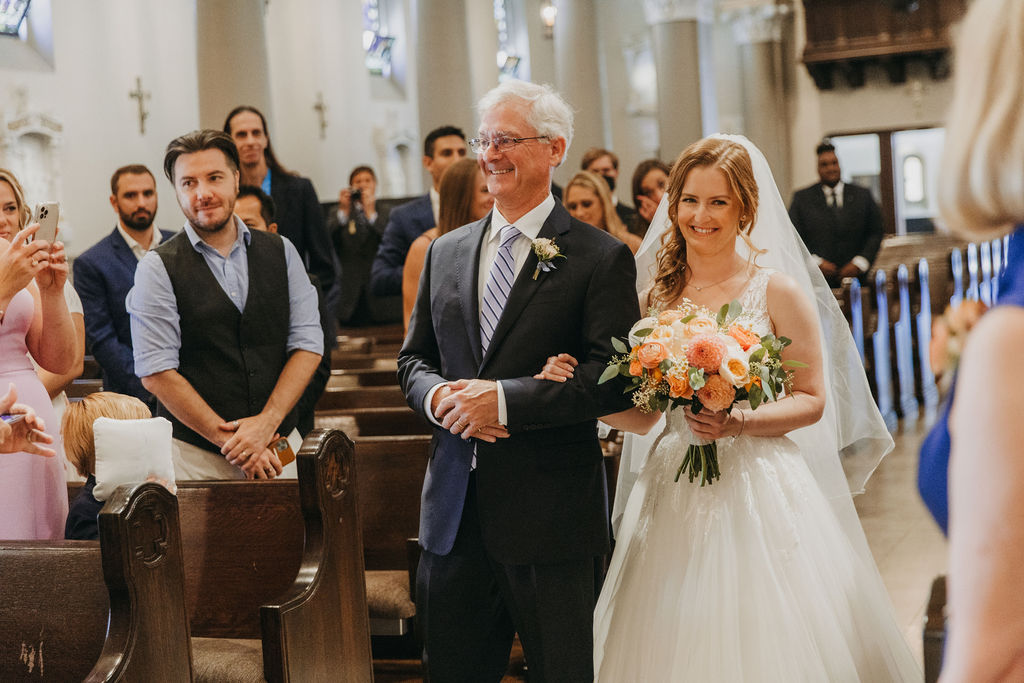 bride walking down aisle with father of bride