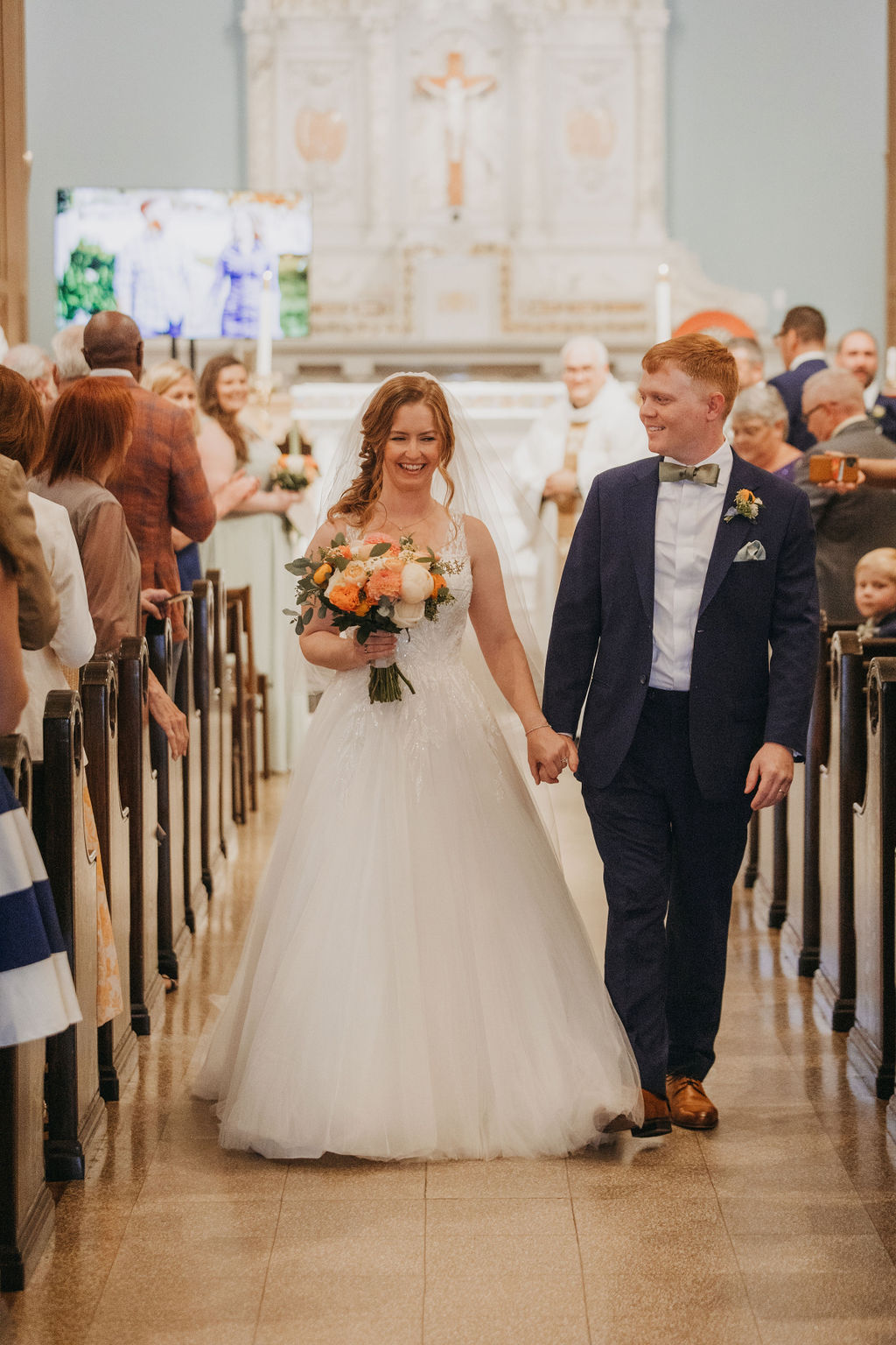 bride and groom recessional after wedding ceremony at Saint Monica Catholic Church