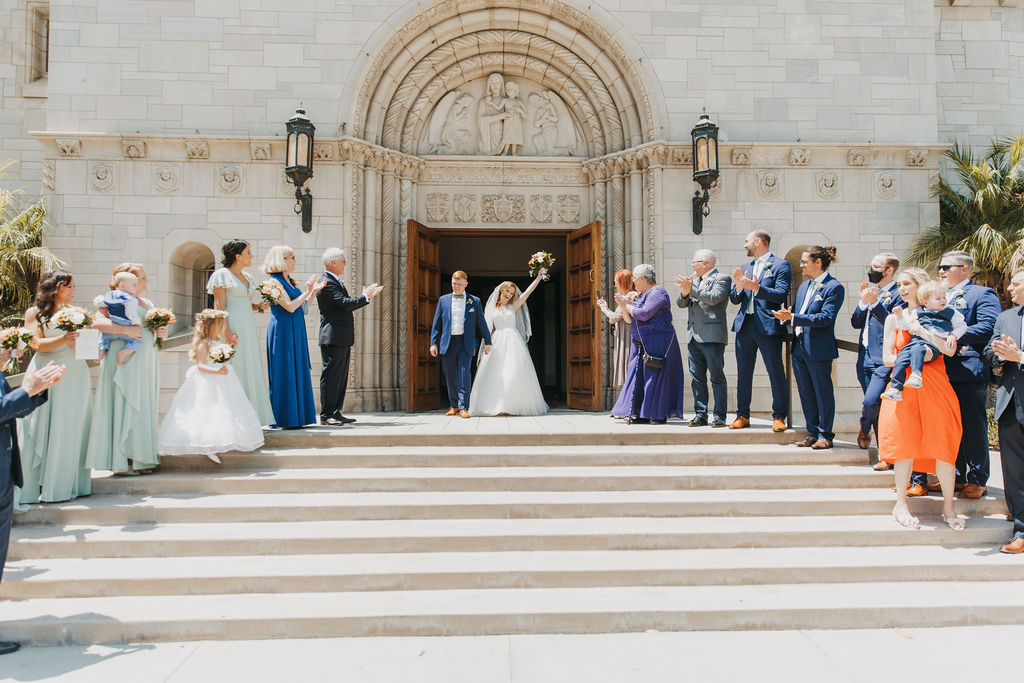 bride and groom recessional on steps after wedding ceremony at Saint Monica Catholic Church
