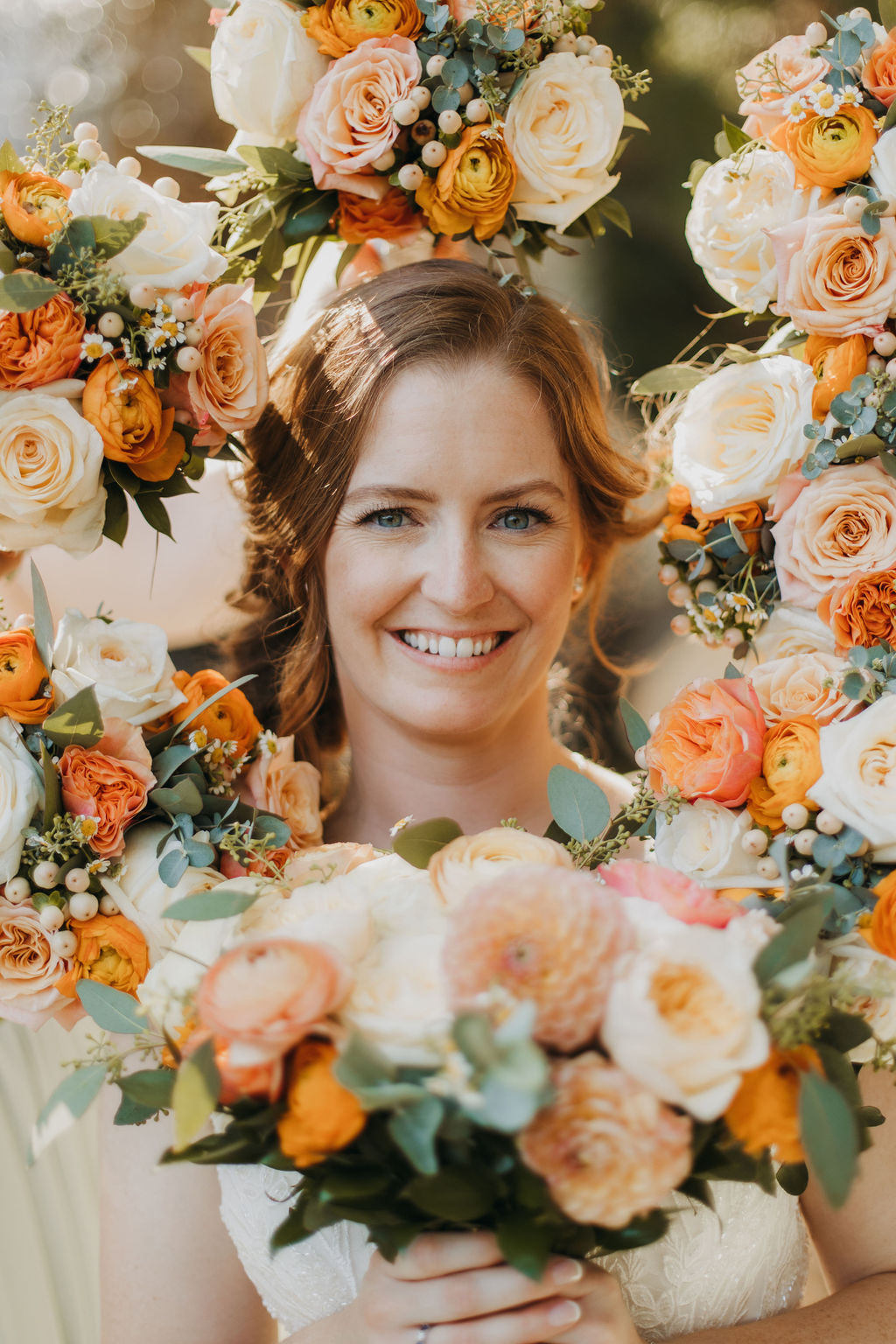 bride portrait shot surrounded by bridesmaid bouquets