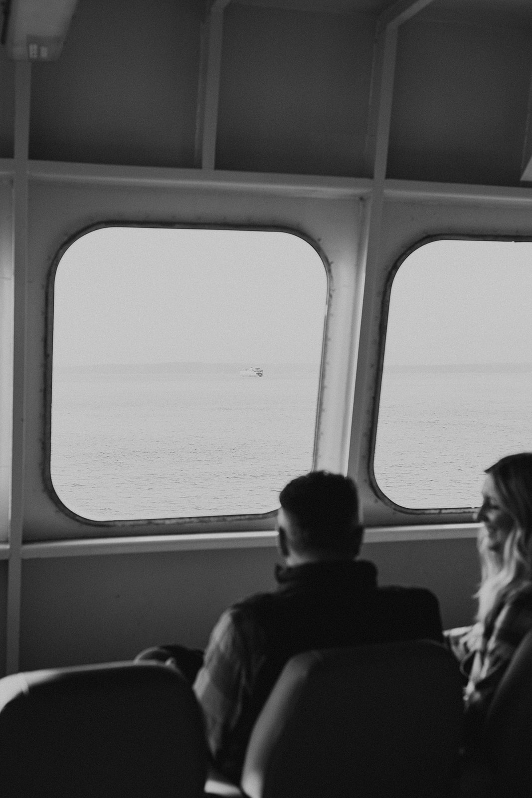 black and white photo of couple on Seattle ferry during fall PNW engagement photo session