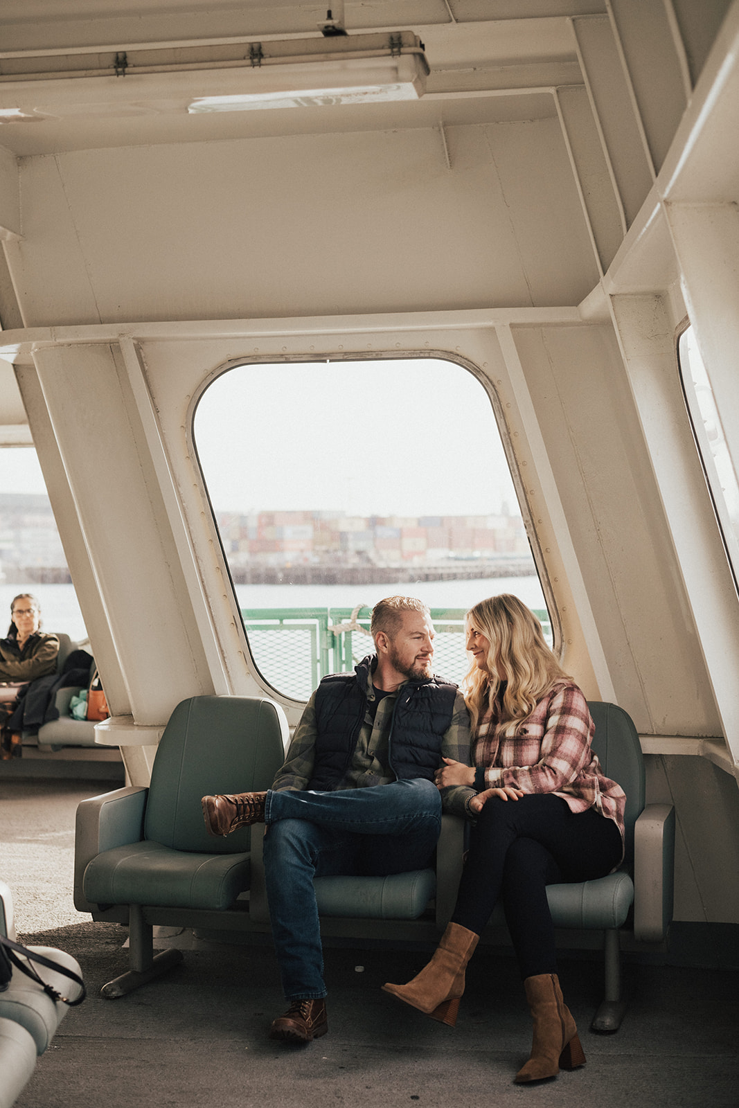 couple together on Seattle ferry during fall PNW engagement photo session